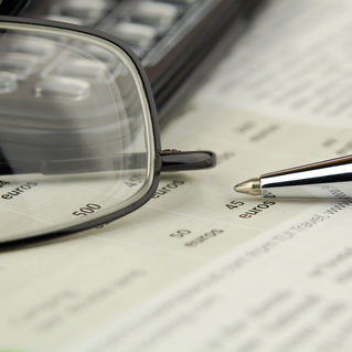 newsletter writing glasses on top of a receipt with a pen